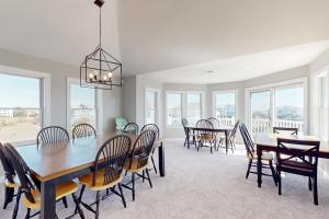 a dining room with a table and chairs at Buhlers Day Off in Corolla