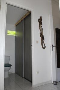 an open door to a bathroom with a toilet at Kaz Manga Rose in Deshaies +5 photos