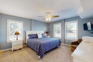 a bedroom with a bed and a ceiling fan at Buhlers Day Off in Corolla +23 photos