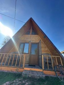 a log cabin with a large front door at Șoaptele Naturii A-frame in Buzău