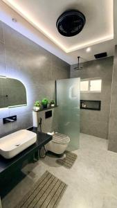 a bathroom with a sink and a tub and a toilet at Luxury Private Room Canal Rd Near Galleria in Faisalabad +6 photos