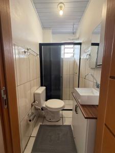 a small bathroom with a toilet and a sink at Apartmento-Studio in União da Vitória +10 photos
