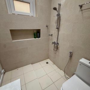 a bathroom with a shower and a toilet at منزل الوادي in Fujairah