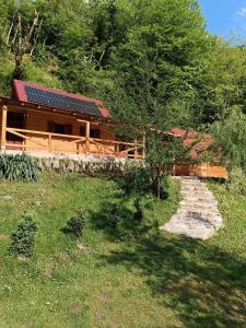 a house with solar panels on top of it at Wildas Cabins, Tara River Canyon in Foča