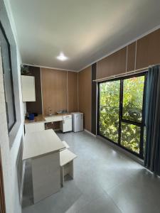 a large kitchen with a large window in a room at Nlife hotel in Kapchagay
