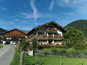 a building with a balcony on the side of a road at Schneider-Hof inkl. Chiemgaukarte in Ruhpolding