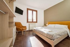 a bedroom with a bed and a desk and a chair at Casa La Polledraia in Venturina Terme