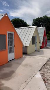 a row of buildings with orange and white at Condomíno dos Chalés in Porto Seguro