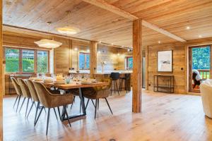 a dining room with a table and chairs at chalet in authentic Manigod farm in Manigod