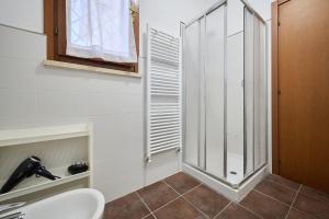 a bathroom with a shower and a sink at Casa La Polledraia in Venturina Terme +28 photos