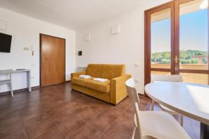 a living room with a couch and a table at Casa La Polledraia in Venturina Terme