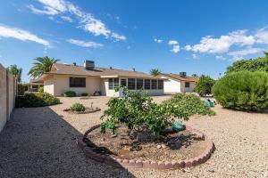 a house with a garden in front of it at CASA Allegro - Active Vacationers Paradise in Sun City West