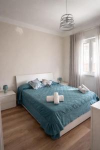 a bedroom with a bed with two towels on it at Maison Louis in Parma