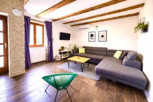 a living room with a couch and a table at Stylish holiday home Lorena in Sveti Juraj