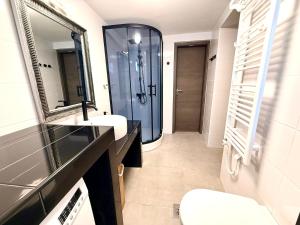 a bathroom with a shower and two sinks and a mirror at Stylish holiday home Lorena in Sveti Juraj +52 photos