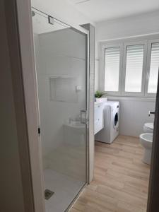 a bathroom with a shower and a toilet in it at Maison Louis in Parma +12 photos