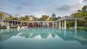 a swimming pool with a fountain in a mansion at Lanna Inthan Hotel & Resort in Doi Saket