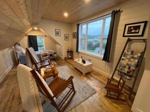 a room with chairs and a window in a room at Wild Cove Retreat & Nook in Twillingate