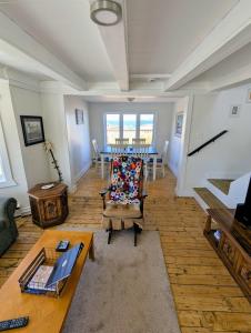 a living room with a table and a couch at Wild Cove Retreat & Nook in Twillingate +24 photos