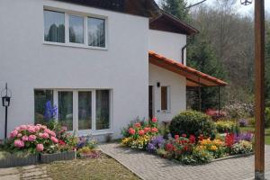 a house with flowers in front of it at Pid Skeleyu in Lazeshchyna
