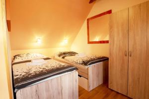 a small room with two beds and a closet at Apartmány v Centru in Třeboň