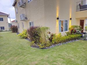 a house with a garden in front of it at The Full Maison at Ocho Rios in Ocho Rios