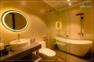 a bathroom with a sink and a toilet and a mirror at Harmony Hotel Nam Định in Như Thức +32 photos
