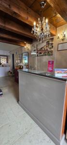 a bar in a kitchen with a chandelier at Relais Ponte Pietra in Verona
