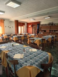 a dining room with tables and chairs in a room at Albergo Bellavista in Re