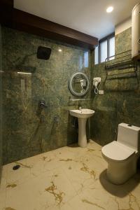 a bathroom with a toilet and a sink at The Heritage Chinar by Ackee Tree in Srinagar +12 photos