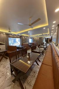 a restaurant with wooden tables and chairs in a room at The Heritage Chinar by Ackee Tree in Srinagar