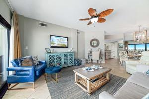 a living room with a couch and a table at The Palms West Unit 515 in Orange Beach +49 photos