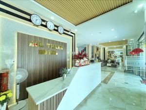 a lobby with clocks on the wall and a counter at ĐỨC THẠNH HOTEL in Rạch Giá