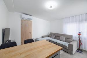 a living room with a couch and a table at Apartments Rea in Krk