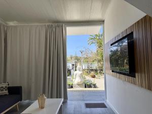 a living room with a couch and a large window at Harmony Deluxe Accommodation in Água de Pau