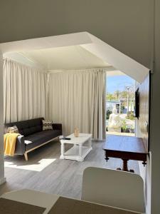 a living room with a couch and a table at Harmony Deluxe Accommodation in Água de Pau +42 photos