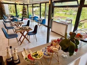 a restaurant with a table with food on it at Harmony Deluxe Accommodation in Água de Pau