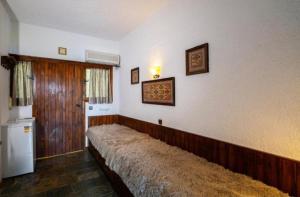 a room with a long bed on a wall at GM View Oropos in Oropos