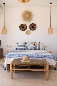 a bedroom with a bed with a blue and white comforter at Villa Luxury Spacious Moroccan ,Private Pool in Essaouira +72 photos