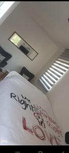 a bed in a room with a ceiling with a window at Apartman Savic 1 Centar in Bijeljina
