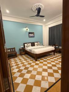 a bedroom with a bed and a checkered floor at Vista villa in Pushkar +7 photos
