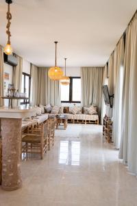 a living room with a couch and a table at Villa Luxury Spacious Moroccan ,Private Pool in Essaouira