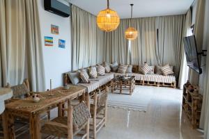 a living room with a couch and a table at Villa Luxury Spacious Moroccan ,Private Pool in Essaouira