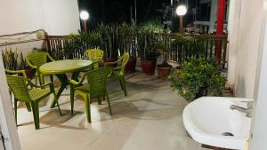 a patio with a table and chairs and a sink at Marble Man Homestay in Agra