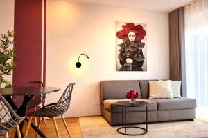 a living room with a couch and a table at M2Suites by BestChoice - Messe - Parking - Self-Check-in in Graz +26 photos
