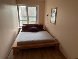 a bed sitting in a room with a window at Vabaduse tn 72 in Narva-Jõesuu