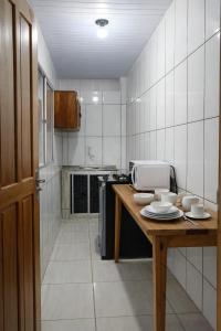 a kitchen with a wooden table with dishes on it at Hotel Star Rio in Novo Airão +9 photos