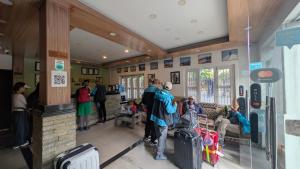 a group of people waiting for their luggage at an airport at Hotel Guru in Pokhara