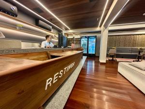 a restaurant with a bar with a person behind a counter at Restinga 305- Flat vista mar no Bessa - ASKA in João Pessoa +70 photos