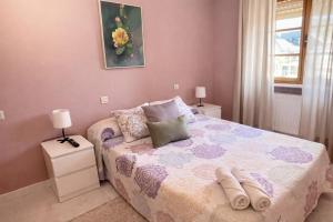 a bedroom with a bed and two night stands and a window at Casa Rural Nito - Naturaleza y Descanso en Asturias in Villayón